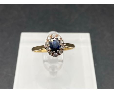 A pretty oval sapphire and diamond cluster ring 9ct size L