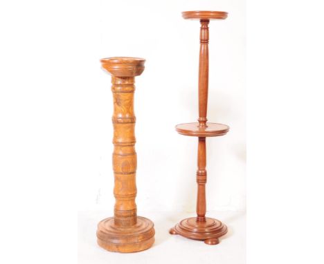 An early 20th century two tier walnut plant stand jardiniere, alongside another oak example. The jardiniere featuring a turne