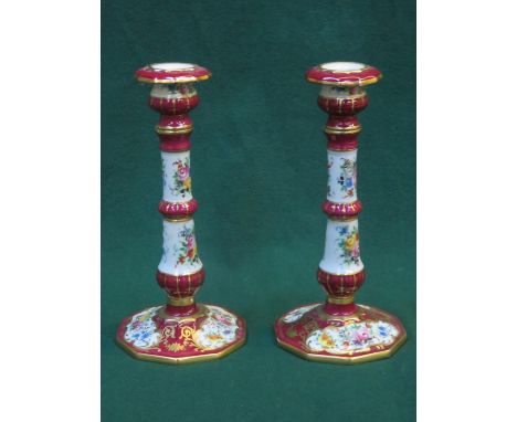PAIR OF FRENCH STYLE HANDPAINTED AND GILDED FLORAL DECORATED CERAMIC CANDLESTICKS BY LIMOGES, APPROXIMATELY 23cm HIGH 