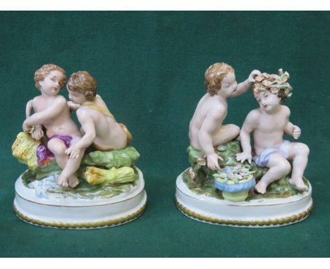 PAIR OF CONTINENTAL STYLE HANDPAINTED AND GILDED CERAMIC FIGURE GROUPS, APPROXIMATELY 17cm HIGH 