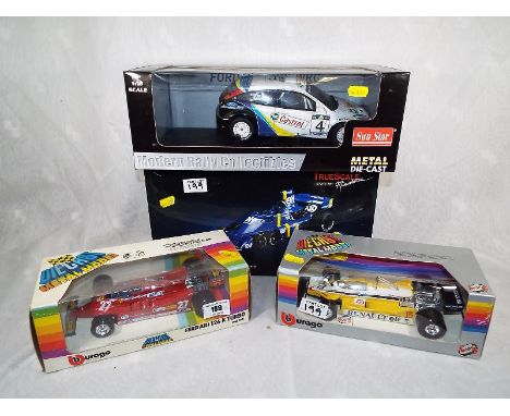 A Sunstar diecast model Ford Focus RS WRC, boxed, two Burago diecast models cars to include a Renault RE30 Turbo and a Ferrar