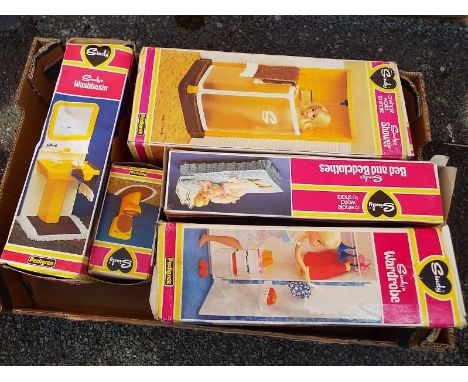 A quantity of vintage Sindy items to include Sindy's Bed, Wardrobe (with clothes) Toilet, Shower and Washbasin, all boxed.  E