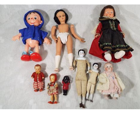A collection of vintage dolls to include some porcelain and straw stuffed examples, three miniature celluloid dolls and simil