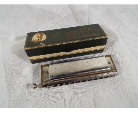 A Koch chromatic harmonica made in Germany with original box - estimate £20 - £40