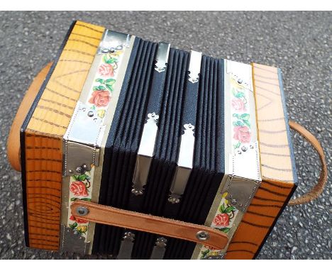 A vintage concertina with attached plaque marked Made in German Democratic Republic (condition near mint) 20 keys, in origina