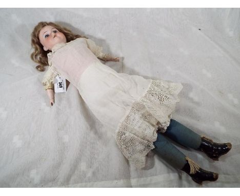 A German doll marked to the back of the neck Flaradora A. 2/0XM made in Germany with glass eyes, open mouth displaying teeth 
