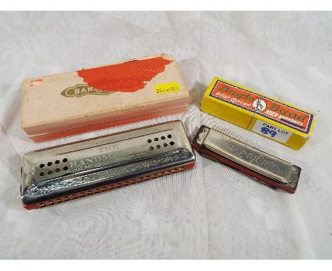 A The Bandmaster chromatic harmonica made in Germany with original box and a Bugle Band Artist Concert Koch Harmonica in orig