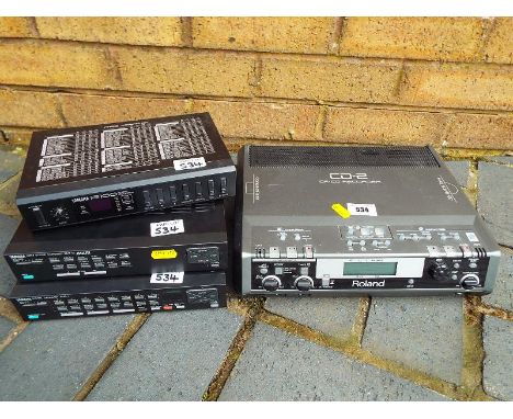A Yamaha digital drummer model number EMR-1, a Yamaha Reverb Processor model number R100, a Yamaha AWM Sound expander model n