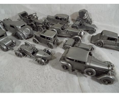 A small collection of scale replica hand crafted pewter vintage motor cars by the Danbury Mint with associated ephemera