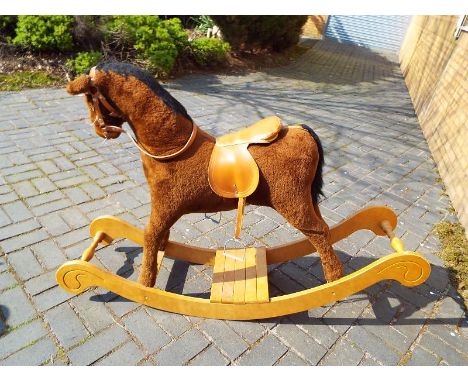 A M J Mark wooden framed rocking horse with saddle and stirrups, approximately 100cm x 150cm