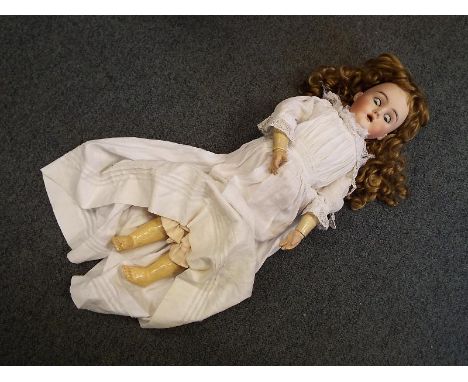 An early 20th century German bisque headed doll by Max Handwerk, fully jointed limbs, light brown wig, sleeping eyes, open mo