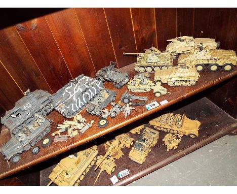 A collection of kit built model German tanks, displayed on two shelves