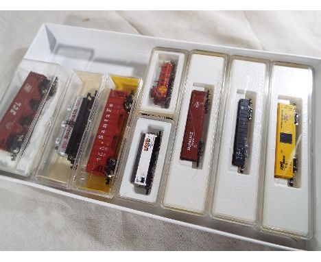 Model railways - eight N gauge goods / freight rolling stock to include Marklin mini-club, (excellent and individually boxed)