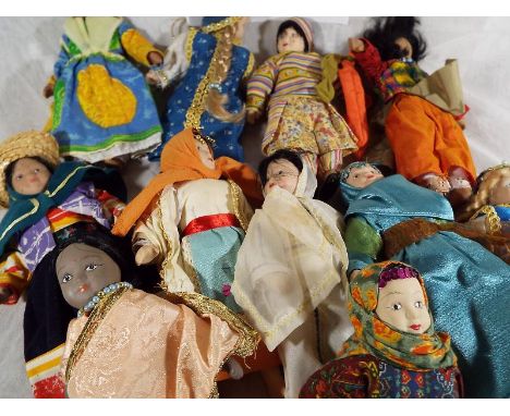 Approximately 30 ceramic ethic dolls, dressed in traditional costumes