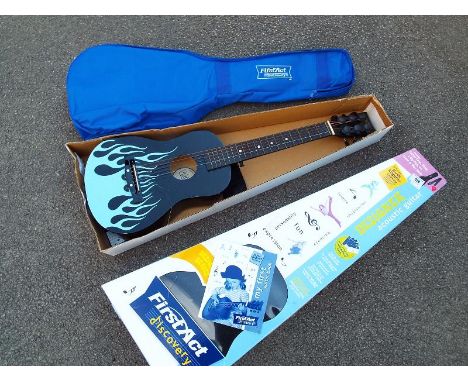 A child's FirstAct Discovery guitar with soft case, manual and original box 