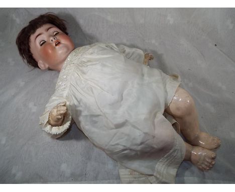 A German bisque headed doll inscribed to the back of the head and neck 1295 FS&C Germany with jointed limbs, sleeping eyes wi