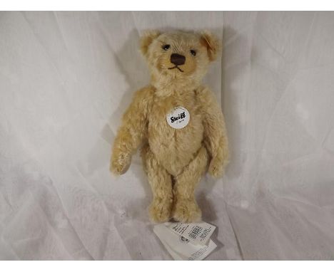 Steiff bear - a Classic mohair teddy bear, blonde, button in ear with yellow tag and attached card label, 30 cm