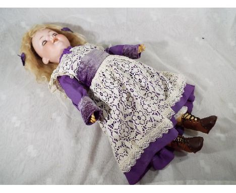 An  Armand Marseille bisque headed doll with jointed limbs, sleeping eyes, open mouth displaying teeth, inscribed 390A.7.M. t