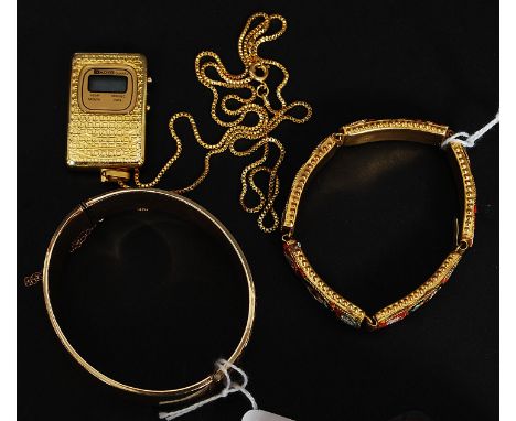 A heavy 9ct gold - metal core rococo chase bangle with safety chain together with a retro quartz clock pendant on necklace an