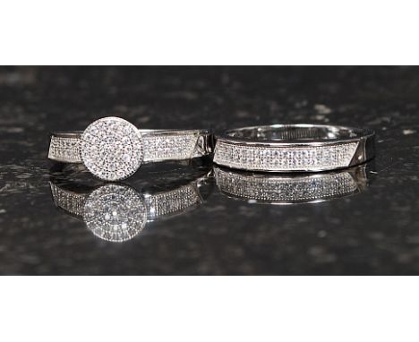 A ladies silver and cz stone inset dress ring with roundel head together with a matching half eternity ring having inset CZ s