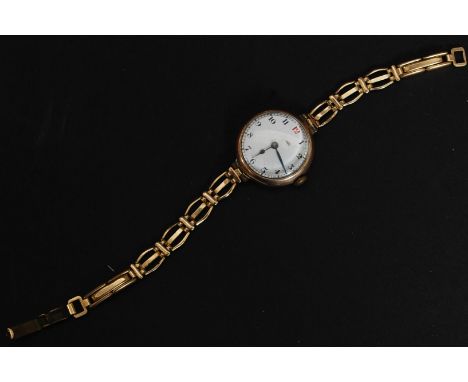 A 9ct / 375 marked gold early 20th century ladies wristwatch having enamel face with good movement. Set on good clasp bracele