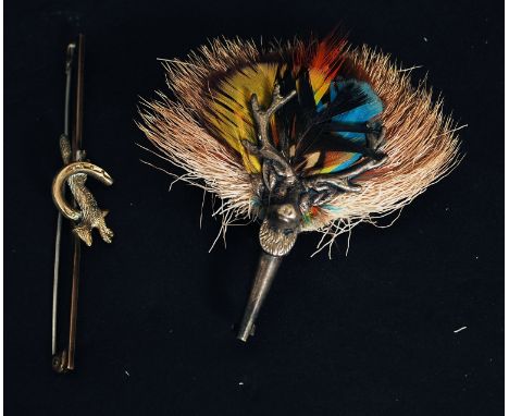 A Scottish white metal stag and partridge plume feather brooch. Together with a rolled gold fox hunting pin bar brooch.

FREE