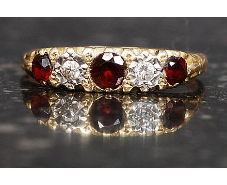 An 18ct gold ring with 3 garnets and 2 4pt diamonds in a gypsy setting. Weight 3.1g. Size R.

FREE UK POSTAGE ON ALL LOTS INC