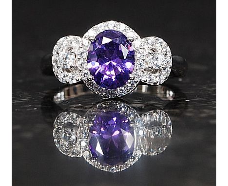 A ladies silver amethyst and cz stone dress ring. The central marquise cut amethyst with cz stone borders. Total weight 4.7g 