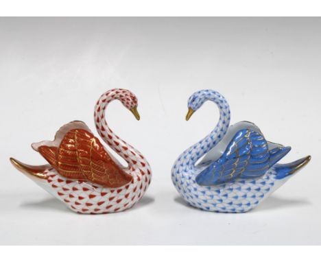 Two Herend handpainted fishnet porcelain swans, one in blue and the other red, with printed factory marks and model number 52