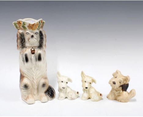Two Beswick dogs, model 805, Sylvac dog model 1119 and a Staffordshire dog jug, 26cm (4)
