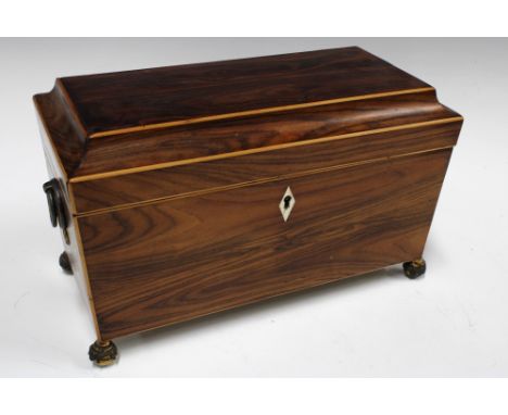 Rosewood sarcophagus tea caddy, the interior with glass mixing bowl and two compartments,  with brass bun feet, 30 x 18cm