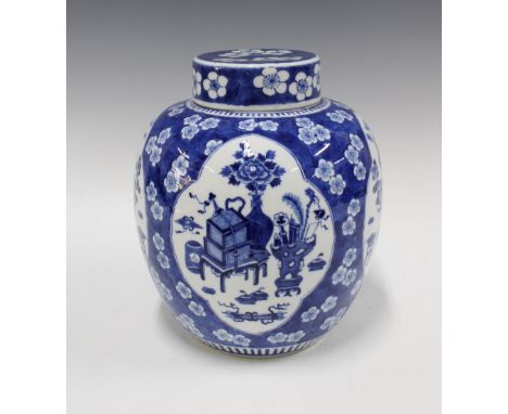 Large Chinese blue and white jar and cover, with prunus ground and panels of precious objects, four character Kangxi mark to 