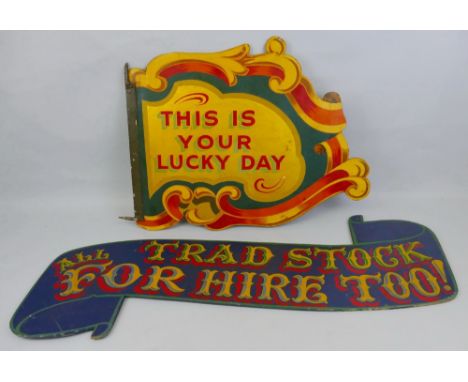 A painted and gilded wooden fairground sign, of two-sided assymetrical form with scrolling edges declaring "This is your luck