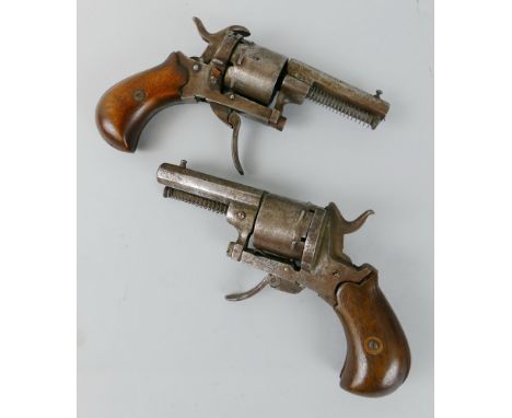 A pair of 7mm pin fire revolvers, each with split walnut stock, folding trigger and later ejector, one with broken hammer, 16