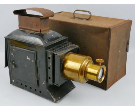 A late Victorian magic lantern, the black japanned steel case with removable brass lens and four-burner acetylene lamp, bears