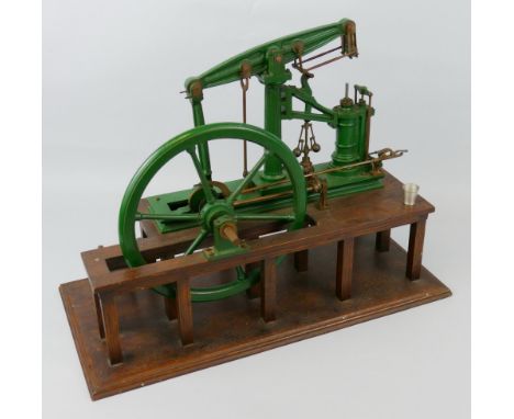A cash-iron model of a factory beam engine, the green painted framework and fly-wheel with brass and iron mounts and fittings