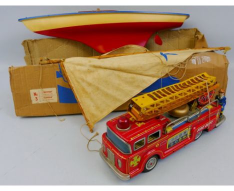 A Seifert Stormbird pond yacht, with red and white painted plastic hull, wooden deck and mast and two linen sails 55cm long, 