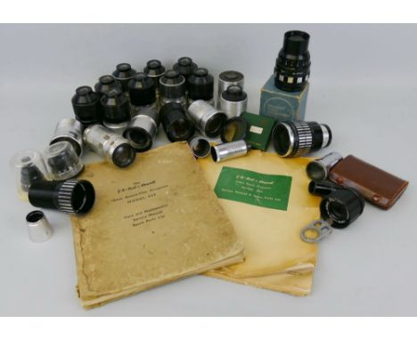 A box containing a selection of mostly Bell and Howell filmosound lenses, together wtih manuals for GB-Bell and Howell 8mm si