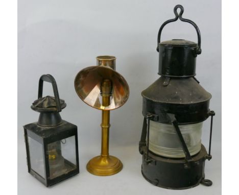 A ship's black painted steel masthead lamp, of cylindrical form with folding handles to top and bottom, glass dated 1943 (no 