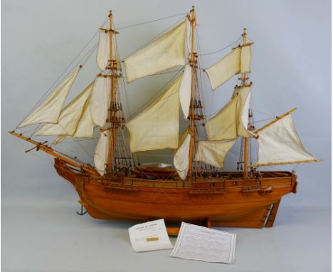 A wooden model of HMS Bounty, with teak hull, deck and fittings and linen sails with rigging, with delivery note from Voilier