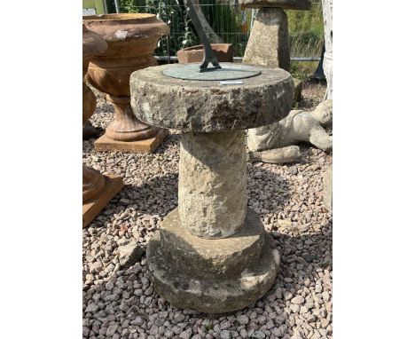 Stone sundial with verdigris brass top