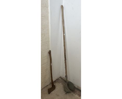 Large vintage long handled ladle together with a long handled felling axe