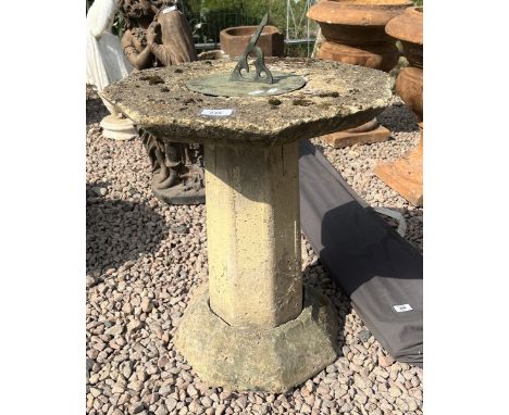 Stone sundial with verdigris brass top