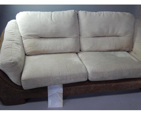 A leatherette finish three seater sofa, with cream chenille upholstered cushions.