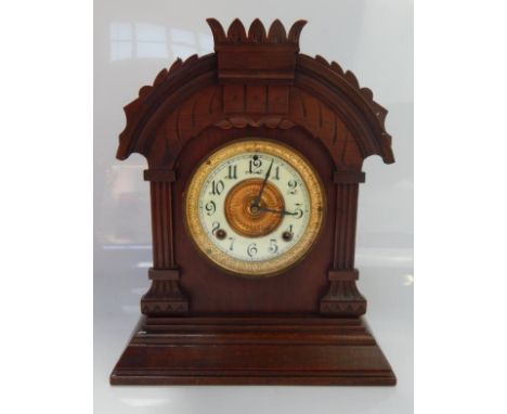 An Ansonia American Tunis 8 day oak mantel clock, having split chapter ring with Arabic numerals, cathedral hands and minute 