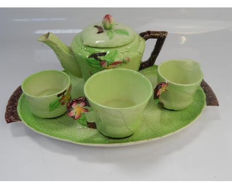 A Carltonware leaf pattern tea service for one, comprising teapot, cup, milk jug, sugar bowl and tray.