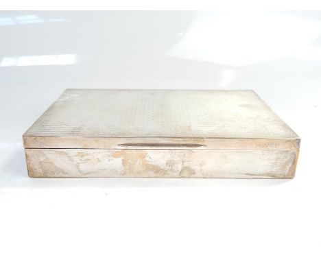 An engine turned mid 20thC engine turned cigarette box, in white metal bearing 925 marks, 22cm wide.