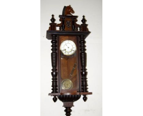A late 19thC Black Forest walnut wall clock, with 8 day movement, 93cm high excluding replacement horse finial. 