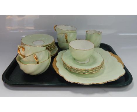 A Coalport part tea service, comprising cups, saucers, side plates and sugar bowl.