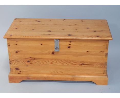 A pine chest/trunk, upon plinth base with bracket feet, 96cm wide.